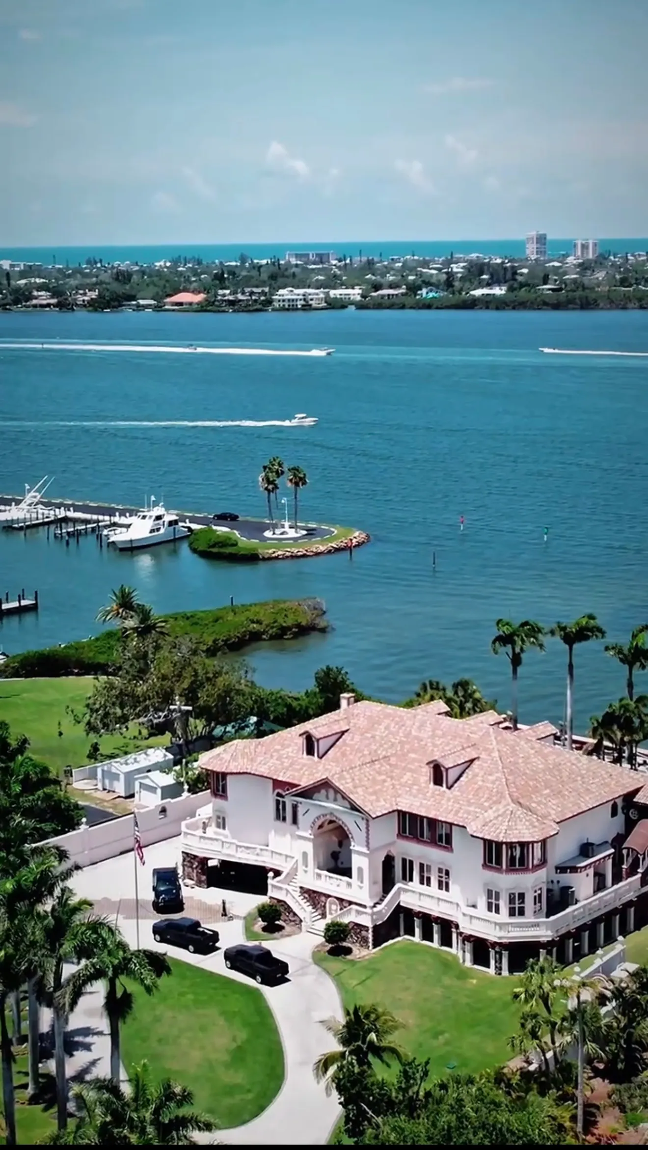 Aerial view of a waterfront luxury estate with a private dock in Sarasota
