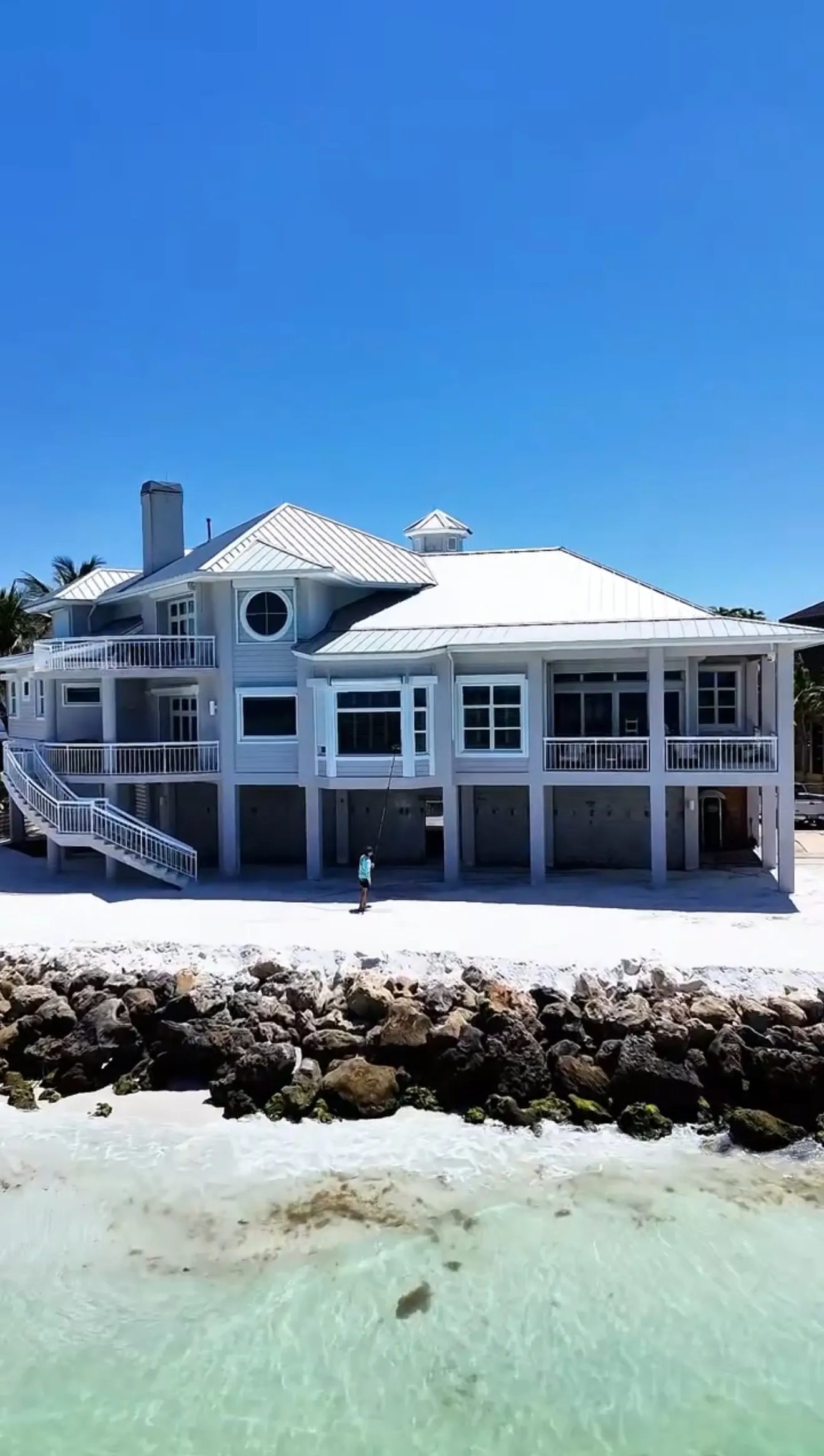 Sunday Cleaning Co. technician cleaning windows on a Gulf-front Sarasota home